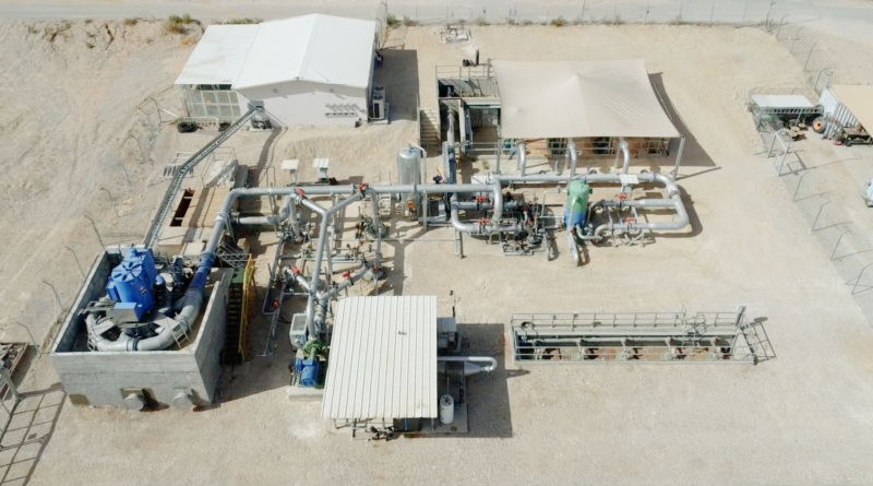 Figure 2. Augwind AirBattery Surface Infrastructure. Aerial view of Augwind&rsquo;s desert-based surface installation showing a complex network of industrial machinery, pipes, compressors, and control structures. The facility includes white-roofed structures and a fenced perimeter. This surface infrastructure is part of the AirBattery system, responsible for compressing air and directing it into underground storage or releasing it to generate electricity during peak demand. The system plays a key role in bridging renewable energy generation with reliable energy supply.